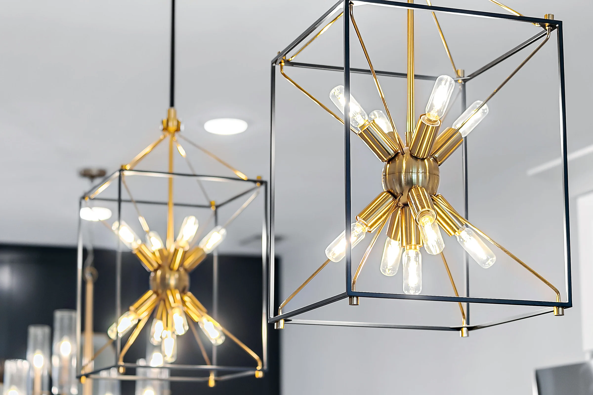 Geometric pendant lights over a kitchen island